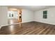 Spacious living room featuring hardwood floors, neutral paint, and a seamless open layout at 6480 Port A Prince Drive Dr, Forest Park, GA 30297