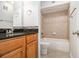 Bathroom features granite countertops, wood grain cabinets, and a tile-surround bathtub at 1445 Monroe Ne Dr # F10, Atlanta, GA 30324