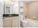 Bathroom with a dark countertop vanity and tiled shower/bath combination featuring a toilet at 1445 Monroe Ne Dr # F10, Atlanta, GA 30324