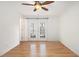 Bright bedroom with hardwood floors, modern ceiling fan, and walkout to outdoor patio at 1445 Monroe Ne Dr # F10, Atlanta, GA 30324