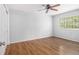 Bright bedroom with hardwood floors, ceiling fan, and a large window for natural light at 1445 Monroe Ne Dr # F10, Atlanta, GA 30324