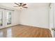Bright bedroom with hardwood floors, modern ceiling fan, and walkout to outdoor patio at 1445 Monroe Ne Dr # F10, Atlanta, GA 30324