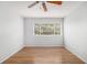 Bedroom featuring hardwood floors, ceiling fan, and a large window that allows natural light at 1445 Monroe Ne Dr # F10, Atlanta, GA 30324