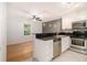 Eat-in kitchen featuring stainless steel appliances, granite countertops, and natural lighting at 1445 Monroe Ne Dr # F10, Atlanta, GA 30324