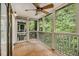 Relaxing screened porch features ceiling fan, tile floor, and a backyard with trees view at 1445 Monroe Ne Dr # F10, Atlanta, GA 30324