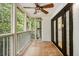Cozy screened porch with ceiling fan overlooking a lush backyard with views of trees at 1445 Monroe Ne Dr # F10, Atlanta, GA 30324