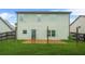 Backyard with a concrete patio, green grass and wood fence at 2166 Villa Spring Ct, Dacula, GA 30019