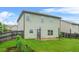 Backyard with a concrete patio, green grass, garden and wood fence at 2166 Villa Spring Ct, Dacula, GA 30019