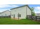 Backyard with a concrete patio, green grass and wood fence at 2166 Villa Spring Ct, Dacula, GA 30019