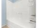 Bathroom features a white bathtub and shower with a chrome shower head and faucet at 2166 Villa Spring Ct, Dacula, GA 30019
