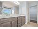 Bathroom with a double sink vanity, tile floor, large mirror, and entry into a walk-in closet at 2166 Villa Spring Ct, Dacula, GA 30019