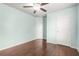 Bedroom with wood floors, ceiling fan, and two white doors at 2166 Villa Spring Ct, Dacula, GA 30019