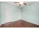 Bedroom with wood floors, a ceiling fan, and two white doors at 2166 Villa Spring Ct, Dacula, GA 30019