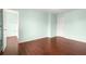 A bedroom with light blue walls, a wood floor, and two doors at 2166 Villa Spring Ct, Dacula, GA 30019