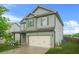 Two-story home with a covered porch, two-car garage, and easy to maintain landscaping at 2166 Villa Spring Ct, Dacula, GA 30019