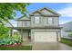 Charming two-story home with a two-car garage, inviting covered porch, and well-manicured lawn at 2166 Villa Spring Ct, Dacula, GA 30019