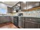 Kitchen features stainless steel appliances, gray cabinets, and ample counter space at 2166 Villa Spring Ct, Dacula, GA 30019