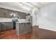Modern kitchen features stainless steel appliances, gray cabinets, a center island and hard wood floors at 2166 Villa Spring Ct, Dacula, GA 30019