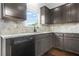 The kitchen features gray cabinets and stainless steel appliances, including a dishwasher and ample counter space at 2166 Villa Spring Ct, Dacula, GA 30019