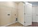 Laundry room with tile floor, washer and dryer connections, and a folding door to the utility room at 2166 Villa Spring Ct, Dacula, GA 30019