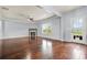 Living room with a fireplace, ceiling fan, hardwood floors and a glass door leading to the backyard at 2166 Villa Spring Ct, Dacula, GA 30019