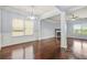 Spacious living room featuring hardwood floors, fireplace, modern lighting, and architectural columns at 2166 Villa Spring Ct, Dacula, GA 30019