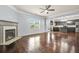 Open living area with hardwood floors, fireplace, and a seamless flow into the modern kitchen at 2166 Villa Spring Ct, Dacula, GA 30019