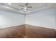 The spacious main bedroom features hardwood floors, a tray ceiling, a ceiling fan and natural light at 2166 Villa Spring Ct, Dacula, GA 30019