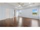 A spacious main bedroom with hardwood floors, a tray ceiling, ceiling fan and two windows for natural light at 2166 Villa Spring Ct, Dacula, GA 30019