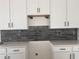 A close up of a grey subway tile backsplash with white cabinets and hardware at 3102 Marbella Cir # 1, Kennesaw, GA 30152