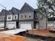 Modern townhomes feature brick exteriors, attached garages, and well-lit driveways at 3102 Marbella Cir # 1, Kennesaw, GA 30152