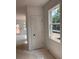 Hallway with a partially completed floor and an interior door, illuminated by a window showcasing the exterior at 3102 Marbella Cir # 1, Kennesaw, GA 30152