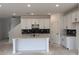 Modern kitchen featuring white cabinets, an island with marble countertop, and stylish dark backsplash tiles at 3102 Marbella Cir # 1, Kennesaw, GA 30152