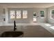 Bright living room with a view of the windows and door, including the countertops and cabinets from the kitchen at 3102 Marbella Cir # 1, Kennesaw, GA 30152