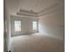 Spacious primary bedroom with a tray ceiling and natural light at 3102 Marbella Cir # 1, Kennesaw, GA 30152