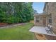 Picture of backyard featuring stone wall, covered patio, and well-manicured lawn, perfect for entertaining at 7027 Walham Grv, Duluth, GA 30097