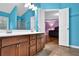 Bathroom with a double sink vanity leading to a bedroom with hard wood floors at 7027 Walham Grv, Duluth, GA 30097