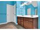 Bathroom featuring double sink vanity with tile flooring, and bright blue walls at 7027 Walham Grv, Duluth, GA 30097