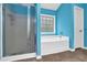 Bathroom with a shower and tub combination, tile flooring and bright blue walls at 7027 Walham Grv, Duluth, GA 30097