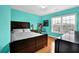 Bedroom with wood floors, a large window, and bright blue walls at 7027 Walham Grv, Duluth, GA 30097