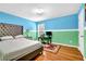 Comfortable bedroom with hardwood floors, a large bed, and a desk, perfect for relaxation and productivity at 7027 Walham Grv, Duluth, GA 30097