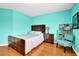 Bedroom featuring wood floors, a large window, and bright blue walls at 7027 Walham Grv, Duluth, GA 30097