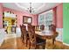 Elegant dining room with hardwood floors, a chandelier, and ornate wooden furniture at 7027 Walham Grv, Duluth, GA 30097