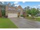 Beautiful two-story brick house with a lush green lawn and a double garage at 7027 Walham Grv, Duluth, GA 30097