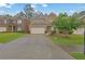 Charming two-story brick home with a well-manicured lawn and two-car garage at 7027 Walham Grv, Duluth, GA 30097