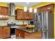 A lovely kitchen has an island, stainless steel appliances, and granite countertops at 7027 Walham Grv, Duluth, GA 30097