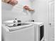 Efficient laundry room equipped with modern, matching washer and dryer units with convenient overhead storage at 7027 Walham Grv, Duluth, GA 30097