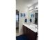 Bathroom with double vanity, decorative art, and coordinated blue accents, providing a clean and stylish space at 2080 Belmont Cir, Conyers, GA 30012