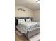 Relaxing bedroom featuring a tufted headboard, plush rug, and a decorative floral accent on the wall at 2080 Belmont Cir, Conyers, GA 30012