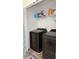 Laundry room with side-by-side black washer and dryer at 2080 Belmont Cir, Conyers, GA 30012